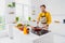 Photo of young handsome man cook tasty family meal morning breakfast frying food pan cuisine indoors