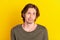 Photo of young handsome man unhappy sad negative shrug shoulders confused dilemma isolated over yellow color background