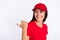 Photo of young happy cheerful lovely charming service girl point finger copyspace promo isolated on grey color