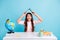 Photo of young happy childish funky excited happy smiling girl hold book above head isolated on blue color background