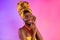 Photo of young happy dark skin lady wear tribal headwrap touch face hands isolated on vivid light background