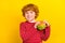 Photo of young happy positive cheerful small boy hold hands cheeseburger smile isolated on yellow color background