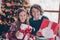 Photo of young happy siblings hold present box xmas enjoy holiday childhood indoors inside house