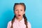 Photo of young little girl amazed shocked surprised stupor fake novelty news isolated over blue color background