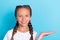 Photo of young little girl happy positive smile show object advert suggest select isolated over blue color background