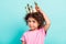 Photo of young little hispanic girl child moody hand touch crown royal isolated over turquoise color background