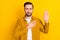 Photo of young man hands on chest make oath swear tell truth justice isolated over yellow color background