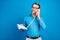 Photo of young man happy positive smile call talk speak conversation phone look empty space isolated over blue color