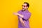 Photo of young man happy positive smile dancer party cluber cool look empty space isolated over yellow color background