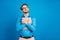 Photo of young man hug cuddle embrace laptop dream look empty space isolated over blue color background