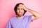 Photo of young man upset stressed depressed bite lips hand cover forehead isolated over pink color background