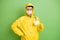 Photo of young man wear protective uniform mask gloves goggles coronavirus show badge isolated over green color