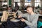 photo of a young man working with linking machine for knitting in textile industry