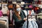 Photo of young mother in face mask walks around mall doing shopping