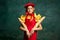 Photo of young pensive girl wearing red fashion look holding baguette and looking at camera over dark vintage background