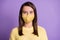 Photo of young pretty brunette girl wear facial mask casual knitted yellow sweater isolated color purple background