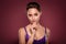 Photo of young pretty charming girl hand touch chin think dream  over burgundy color background