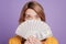 Photo of young pretty woman closing face bunch of dollars rich cash isolated over violet color background