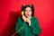 Photo of young scared worried shocked girl talk telephone look copyspace isolated on red color background