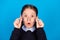 Photo of young school girl amazed shocked surprised hands touch eyeglasses vision  over blue color background