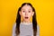 Photo of young school girl amazed surprised afraid scared fail mistake isolated over yellow color background