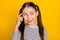 Photo of young school girl happy positive smile think finger touch head remember look empty space  over yellow