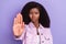 Photo of young serious beautiful african woman showing stop sign restriction deny isolated on purple color background