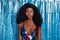 Photo of young serious beautiful gorgeous charming afro girl at party wear colorful singlet  on blue color