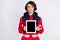 Photo of young serious beautiful woman paramedic demonstrate tablet touchscreen isolated on grey color background