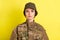 Photo of young serious military person look interested camera isolated on bright yellow color background
