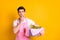 Photo of young serous minded man look copyspace thinking hold basin with clothes isolated on yellow color background