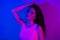 Photo of young stunning beautiful gorgeous girl with long hair posing on camera sensual shot  on neon blue color