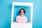 Photo of young stunning cheerful female hold white frame remember moment isolated on blue color background
