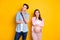 Photo of young think couple stand look empty space pregnant woman wear casual cloth isolated on yellow background