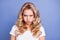Photo of young unhappy upset angry displeased disappointed girl hold breath pout lips isolated on blue color background