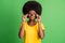 Photo of young unhappy upset mad afro girl in glasses staring angrily having conflict  on green color background