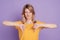 Photo of young upset serious attractive girl woman showing thumb down dislike disapprove isolated on purple color