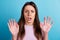 Photo of young woman astonished scared fear nervous panic arms reaction isolated over blue color background