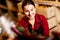 Photo of young woman with bottle in hands in wine shop