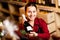 Photo of young woman with bottle in hands in wine shop