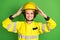 Photo of young woman firefighter correct fix helmet happy positive smile isolated over green color background