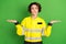 Photo of young woman firefighter hesitate doubt bite lips hold hands solution proposition isolated over green color
