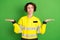 Photo of young woman firefighter hesitate doubt hold hands solution product advert pros cons isolated over green color