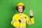 Photo of young woman firefighter serious hand on chest make oath swear isolated over green color background