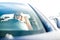 Photo of young woman with glasses driving black car