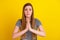 Photo of young woman hands together ask beg pray wish luck wait isolated over yellow color background