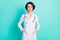 Photo of young woman serious confident doctor therapist hands in pocket isolated over teal color background