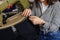 Photo of a young woman working with linking machine for knitting in textile industry