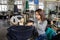 photo of a young woman working with linking machine for knitting in textile industry