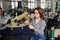 photo of a young woman working with linking machine for knitting in textile industry